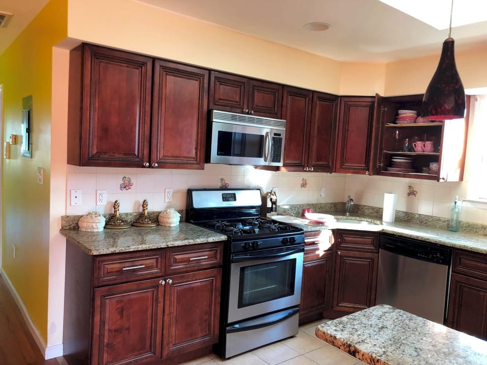 Spacious Kitchen coffee maker( with coffee, filter and sugar), toaster oven, microwave, electric slow cooker, sandwhich maker, cutleries, plates,  bow, glasses