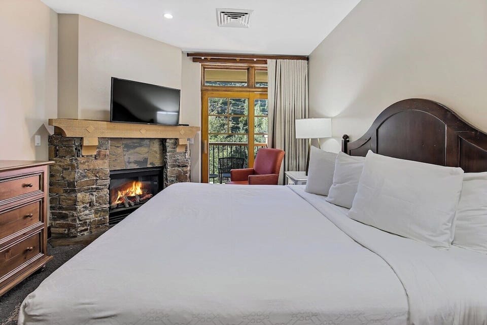 Primary bedroom has a king bed and cozy fireplace