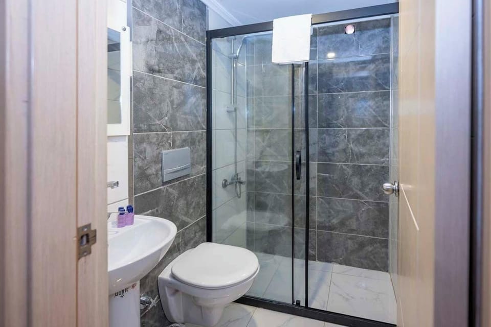 Shower, hair dryer, slippers, towels