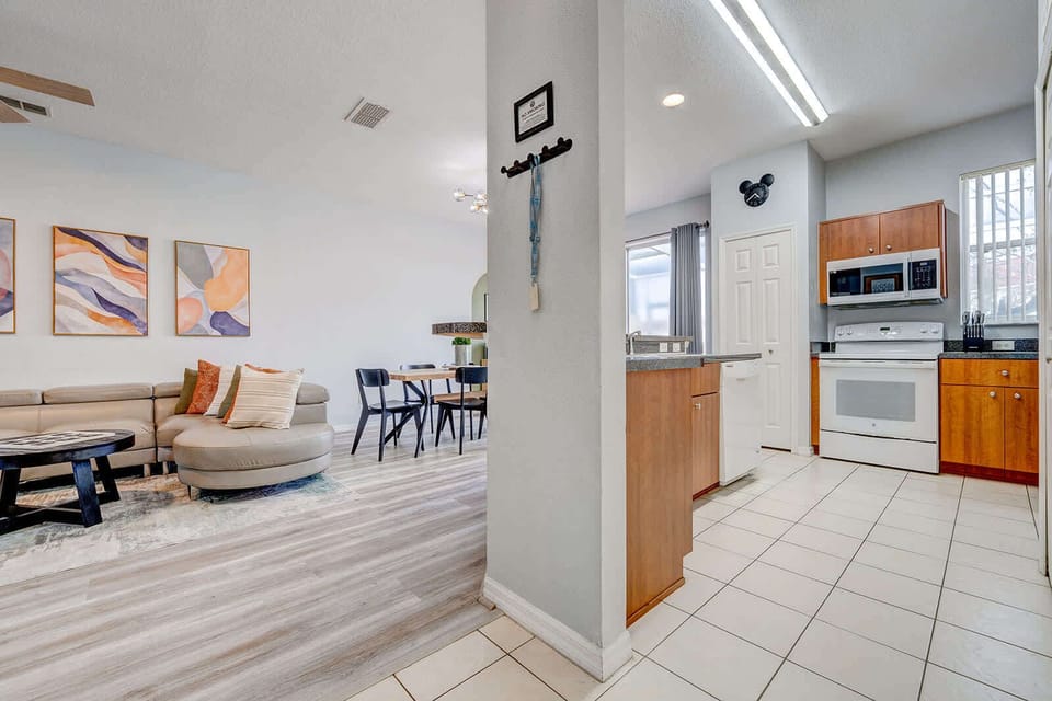 Open kitchen and living area with modern flooring and natural light.