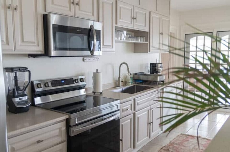 Kitchen is bright and spacious, fully equipped with all your cooking needs. 
