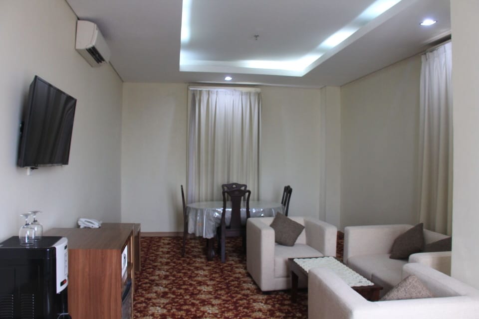 President Suite | Living area | 21-inch LED TV with cable channels, TV