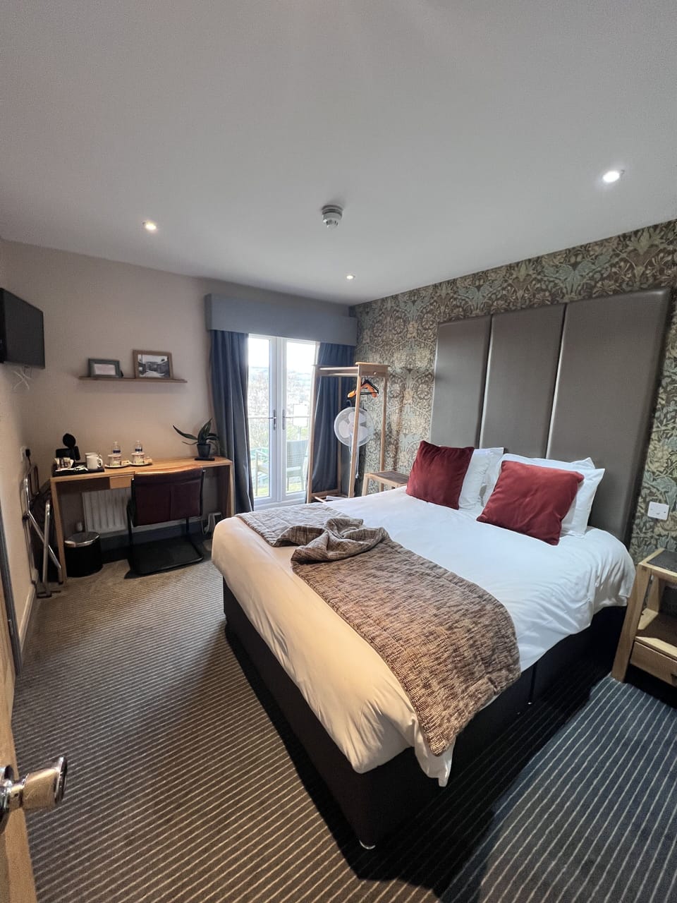 Desk, laptop workspace, iron/ironing board, bed sheets