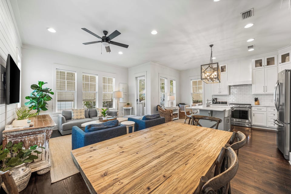 Open-concept dining, living, and kitchen space designed for easy coastal gatherings.