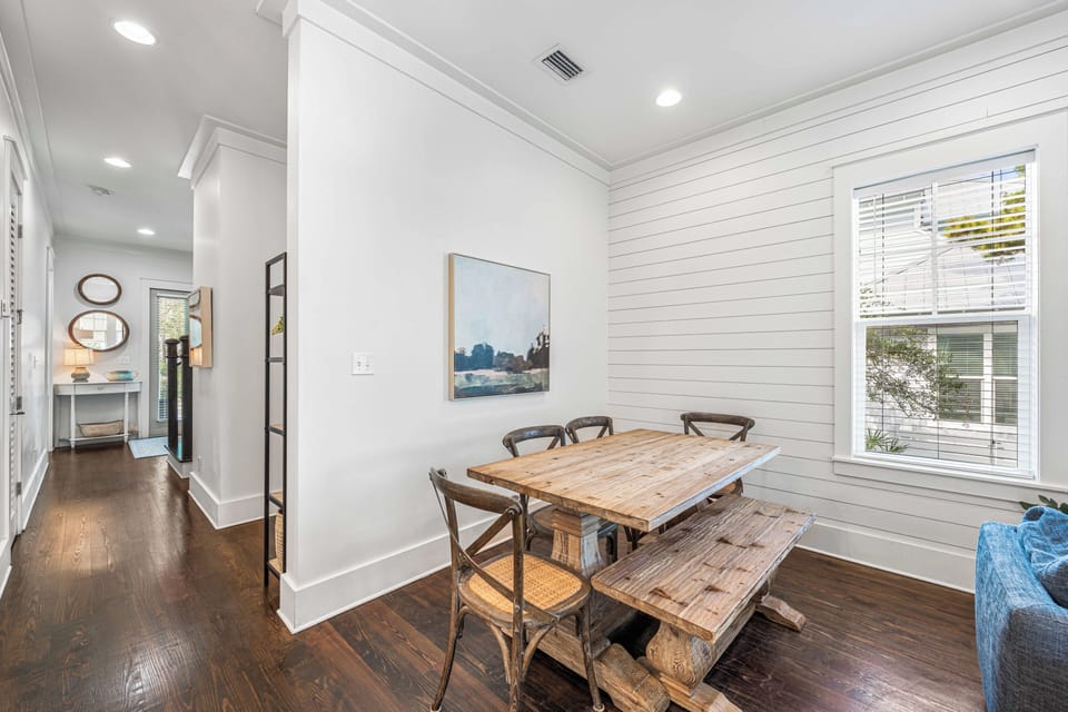 Open-concept dining, living, and kitchen space designed for easy coastal gatherings.