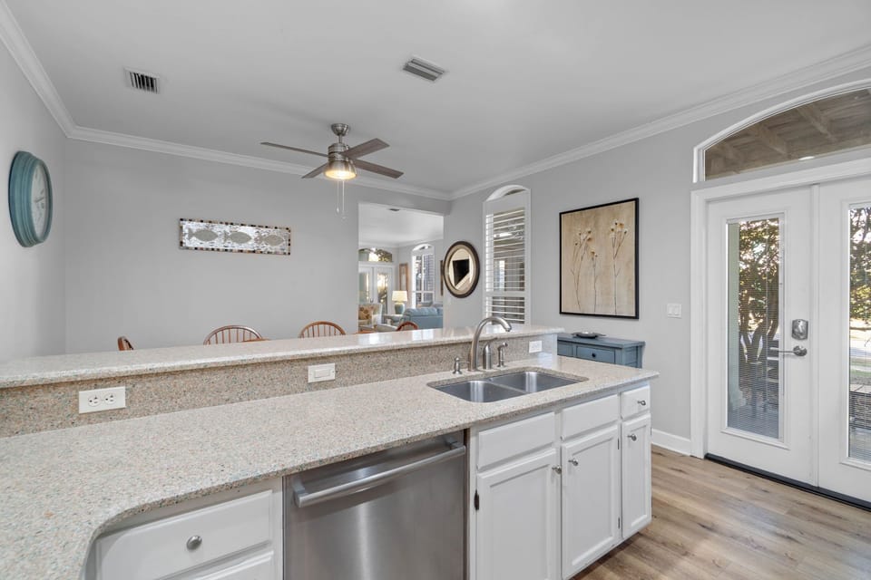 The open well-stocked kitchen leads to the outdoor grill area