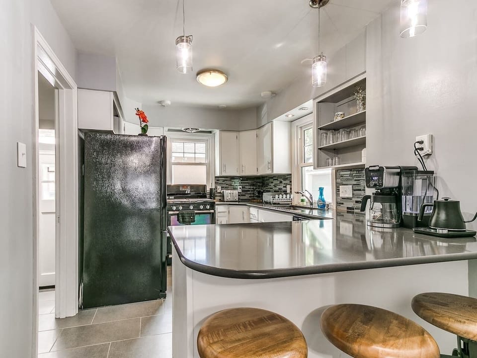 Kitchen with three bar stools.