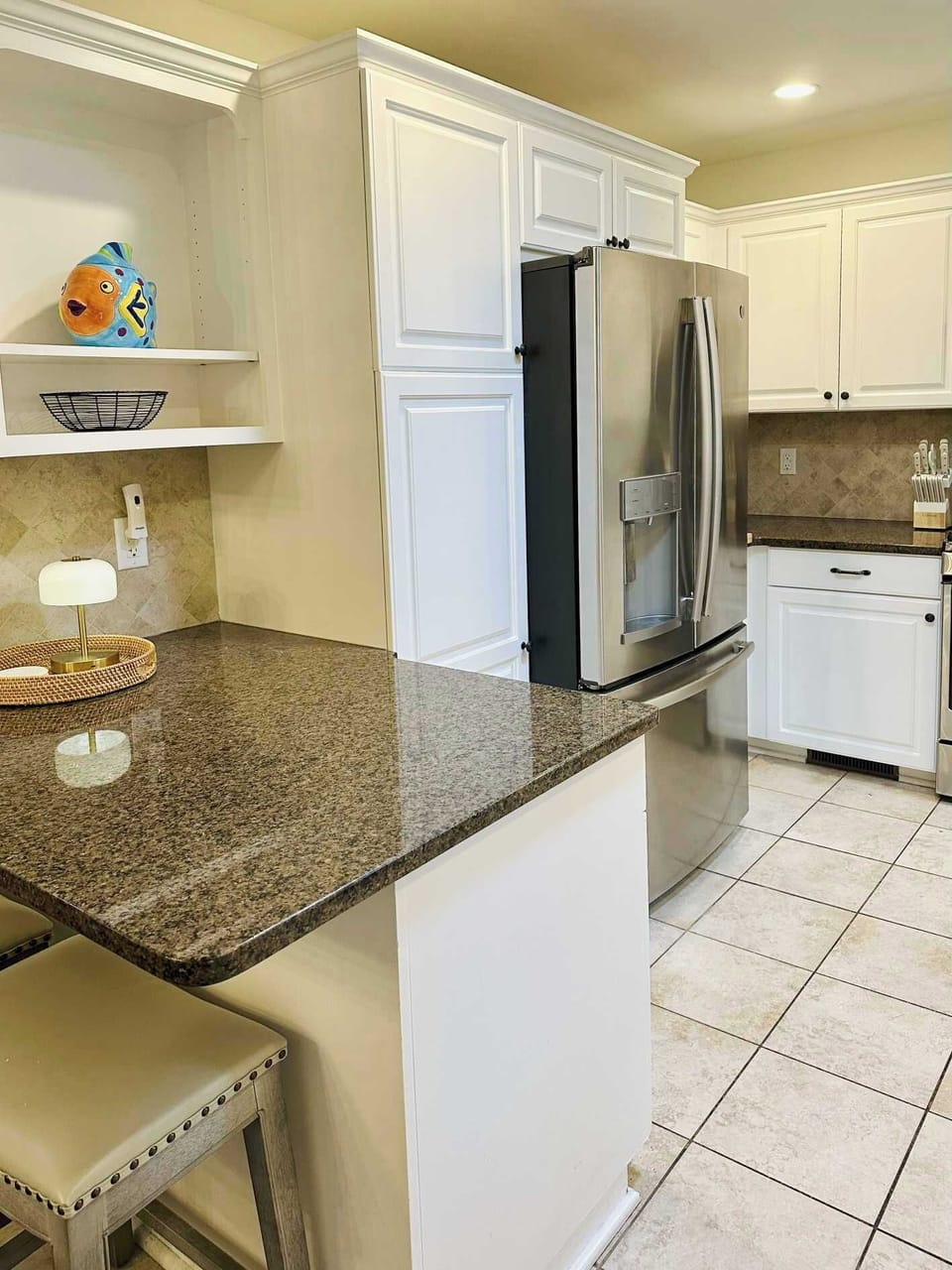 The refrigerator has an ice and water dispenser in the door, and there's a small bar for kids (or adults) to enjoy breakfast or a quick snack.