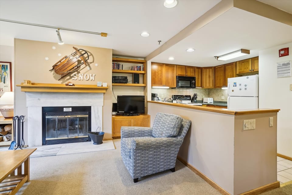 Enjoy an open layout that connects the kitchen, living room, and fireplace area.