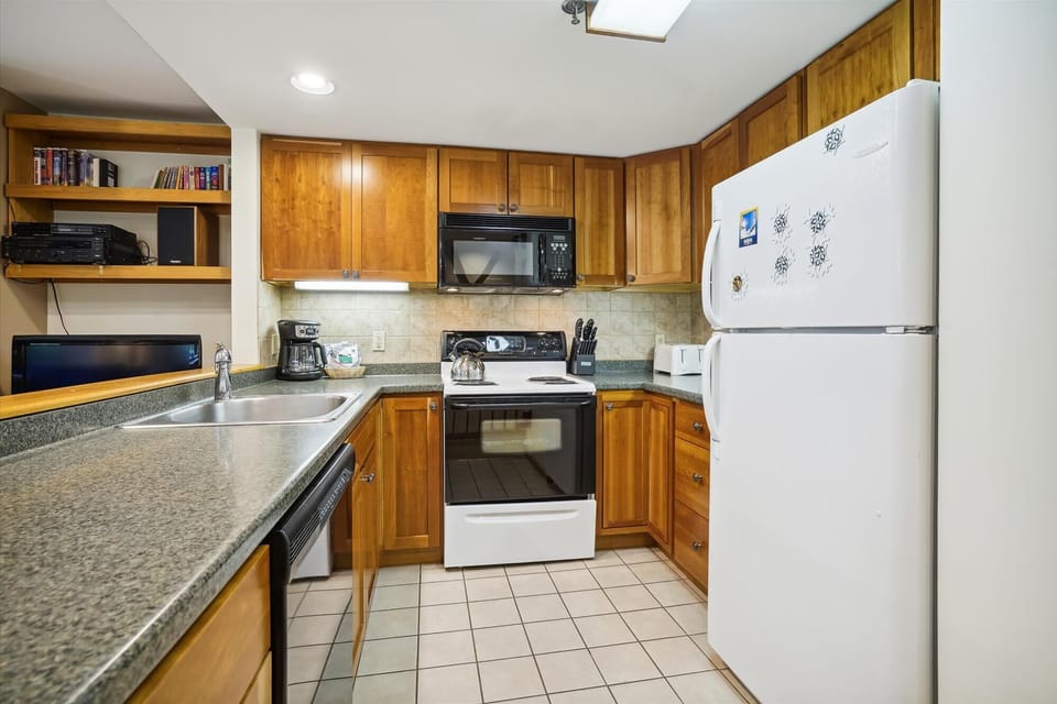 The full kitchen offers ample counter space and everything needed for easy vacation meals.