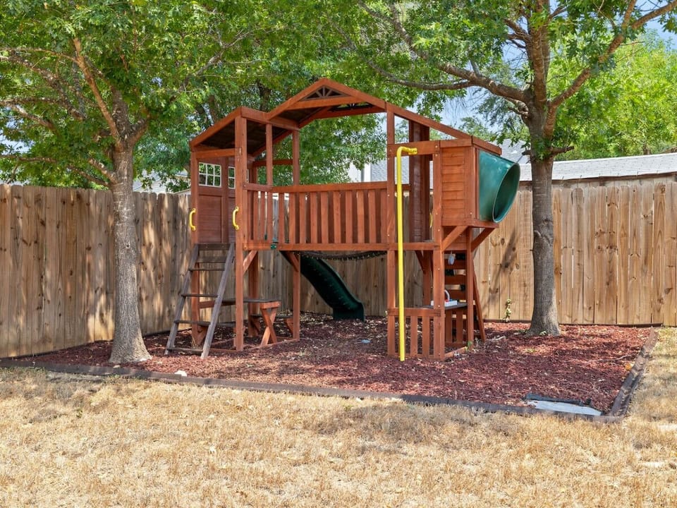 A backyard made for fun! Let the kids enjoy the playset while you unwind in the fresh Austin air