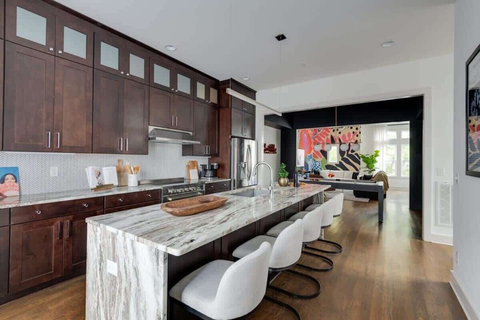Clean and Spacious Kitchen with Sleek Countertops and Additional Seating