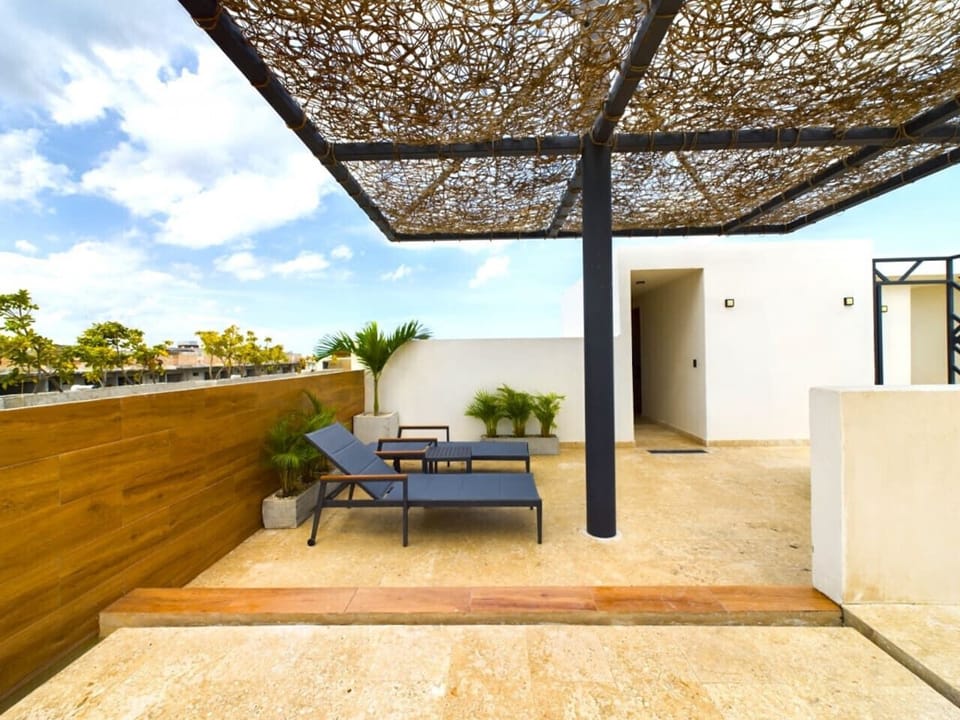 Unwind on your private terrace with sun-ready lounge armchairs.