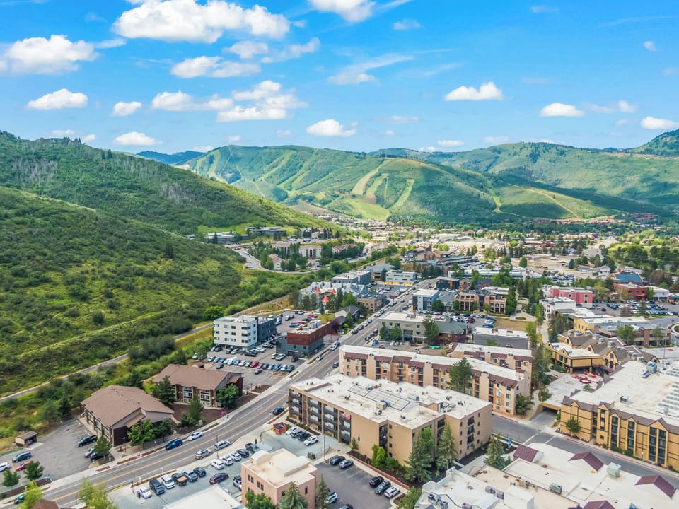 Elevated view showcasing the nearby town and surrounding mountains, highlighting the property's prime location.