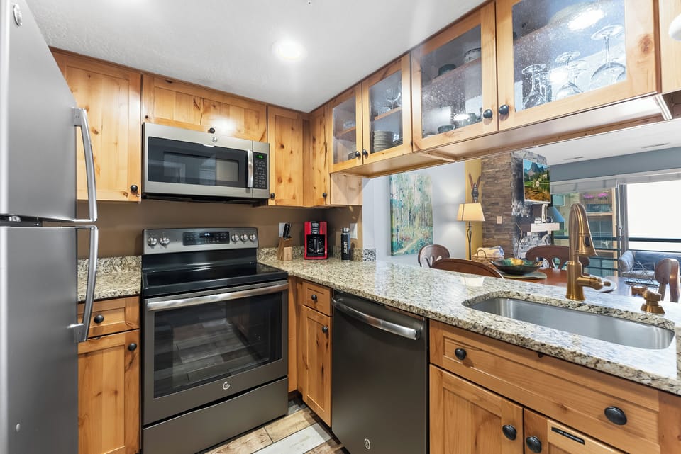 Well-appointed kitchen with stainless steel appliances, granite countertops, and everything needed for cooking at home.