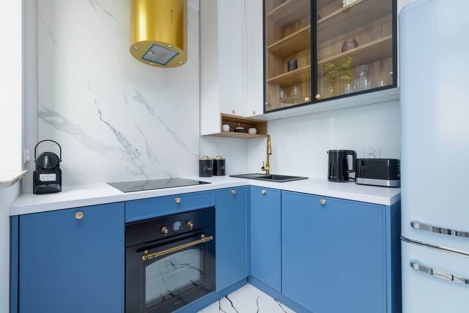 A well-lit open kitchen and dining area, showcasing luxurious finishes, modern furniture, and ample natural light.







