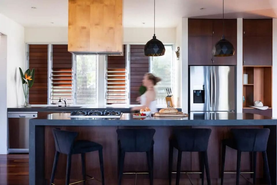 Modern kitchen with island, bar seating, and full amenities. Private chef available on request.