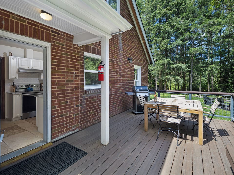 Enjoy the sunshine on the back deck with table and propane bbq.