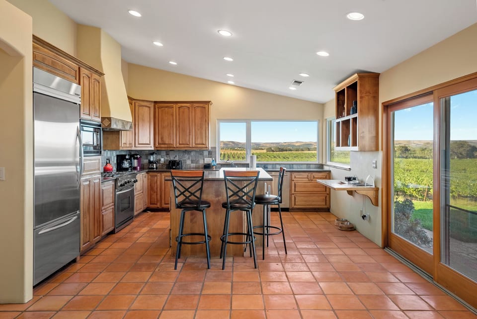 Large full size kitchen with tons of light and a view of the sur