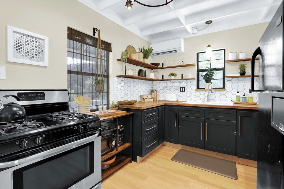 The kitchen is equipped with modern appliances and amble storage space