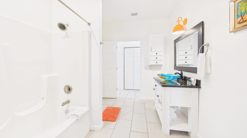 Guest bathroom in hallway with shower and tub combo