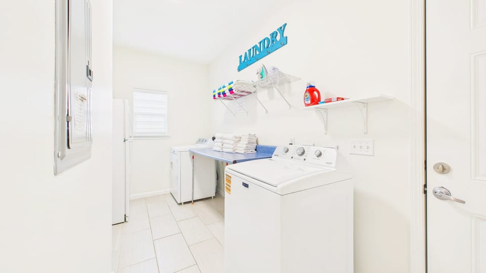 Mud room with washer and dryer machines for guest use
