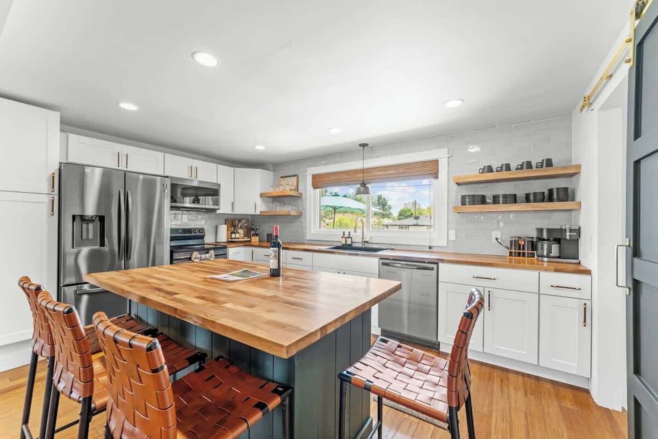 Kitchen (complementary bottle of wine, welcome guide, stainless steel appliances, butcher block island with four chairs, fully stocked with all cooking essentials)