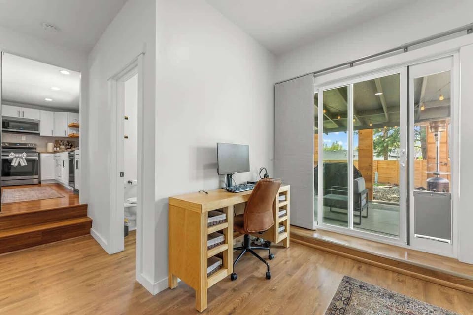 Office workspace (comfortable chair, universal docking station, monitor, keyboard and mouse included, and dog door to back yard)