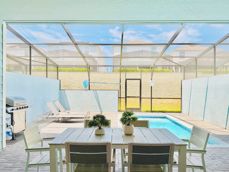 Outdoor covered patio dining table looking onto the private pool.