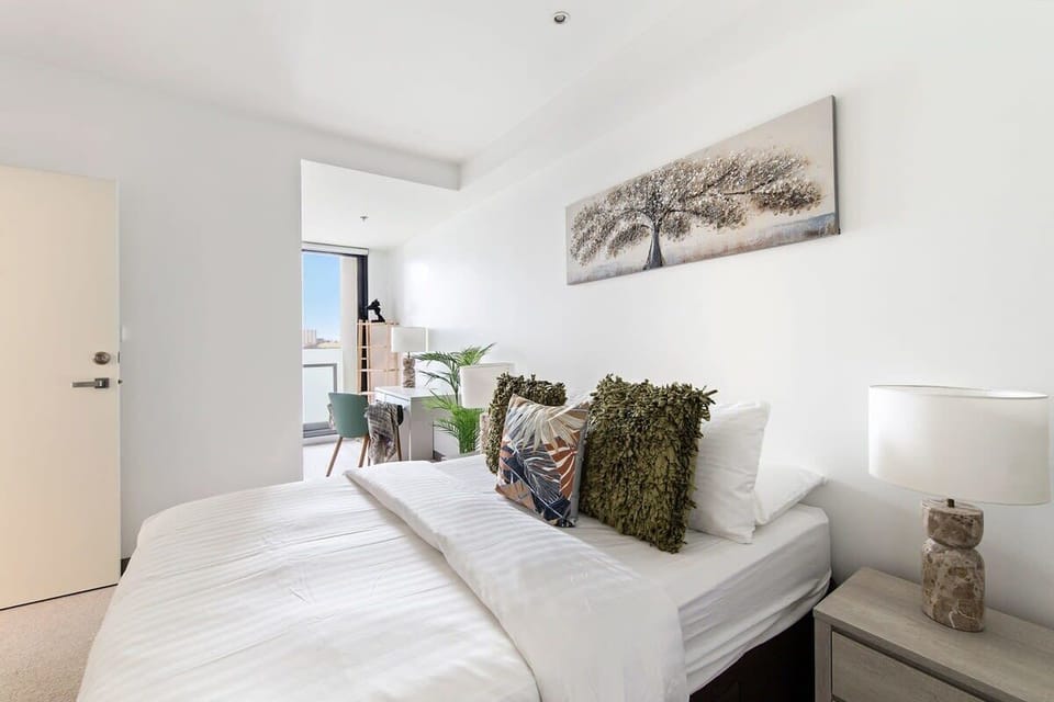 The master bedroom with a queen sized bed & plush pillows.