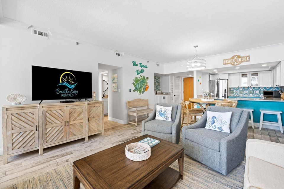 Bright living space flows to dining and a private balcony with views of the pool and sparkling Gulf.

Professionally Managed by
Breathe Easy Rentals