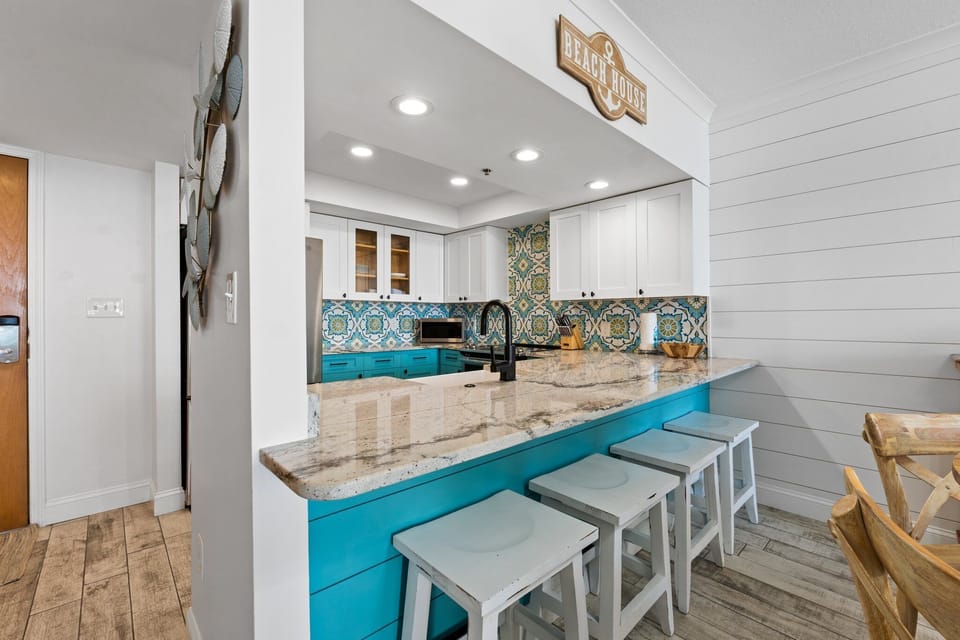 Kitchen with bar seating and a clear view of the cozy living space.

Professionally Managed by
Breathe Easy Rentals