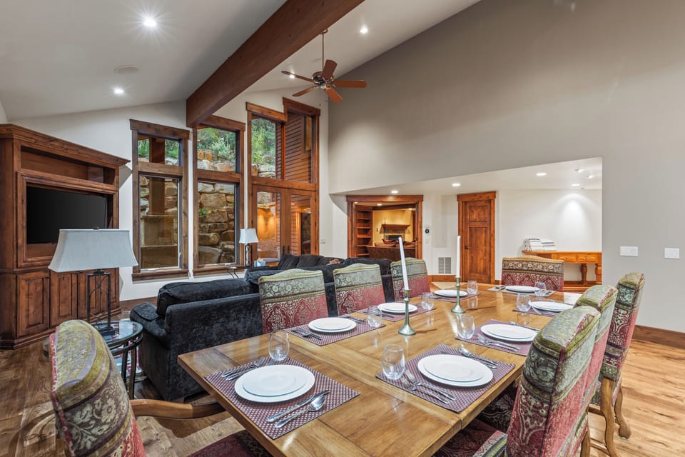 Gather for memorable meals around this large wooden dining table with seating for eight. Enjoy the cozy ambiance and scenic views of the outdoors.