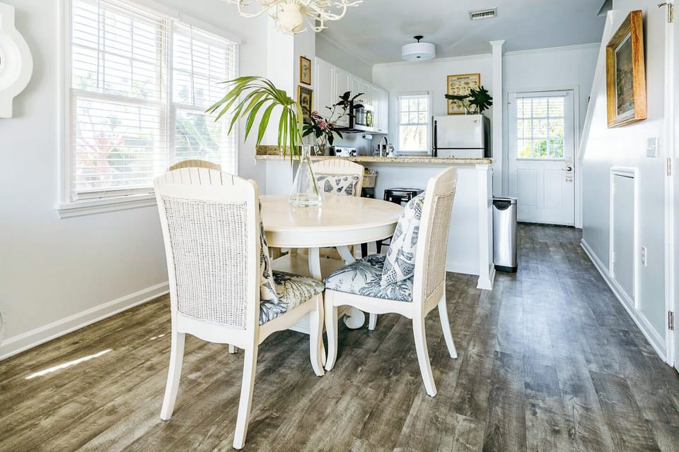 A breakfast bar abuts the formal dining area. Both areas double as workspaces.