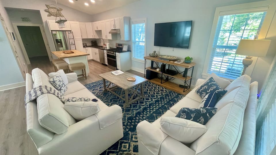 Enjoy our spacious open-concept living room! The area includes a queen-size pullout sofa for extra sleeping options. Relax and savor the aroma of home-cooked meals from the fully equipped kitchen—perfect for family gatherings and cozy nights in.