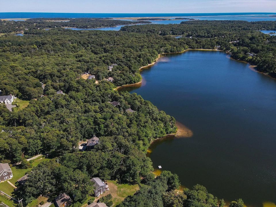 Aerial view of house (bottom center), lawn, Crystal Lake, & SE to Atlantic Ocean