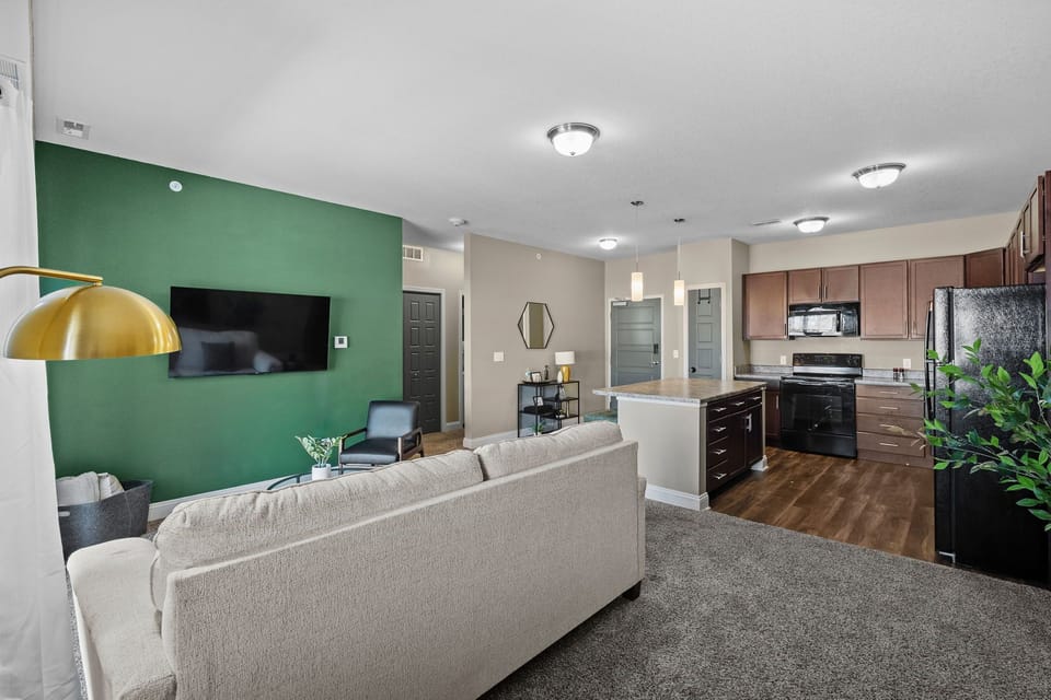 Open-concept living and kitchen area designed for comfort.  Plenty of seating, a smart TV, and a full kitchen make it easy to relax, work, or settle in for a longer stay.