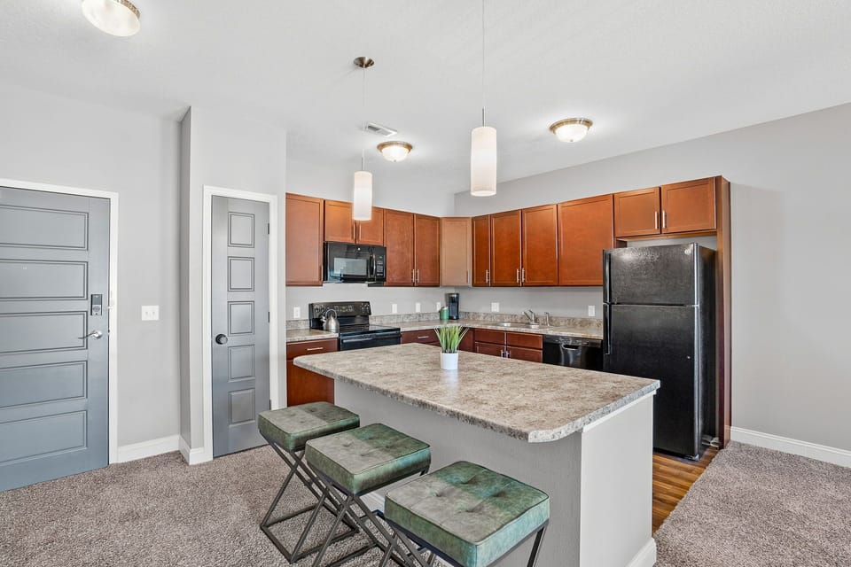 Spacious and stylish, this open-concept kitchen includes modern appliances, a large island with seating, and everything you need to cook or snack in comfort.