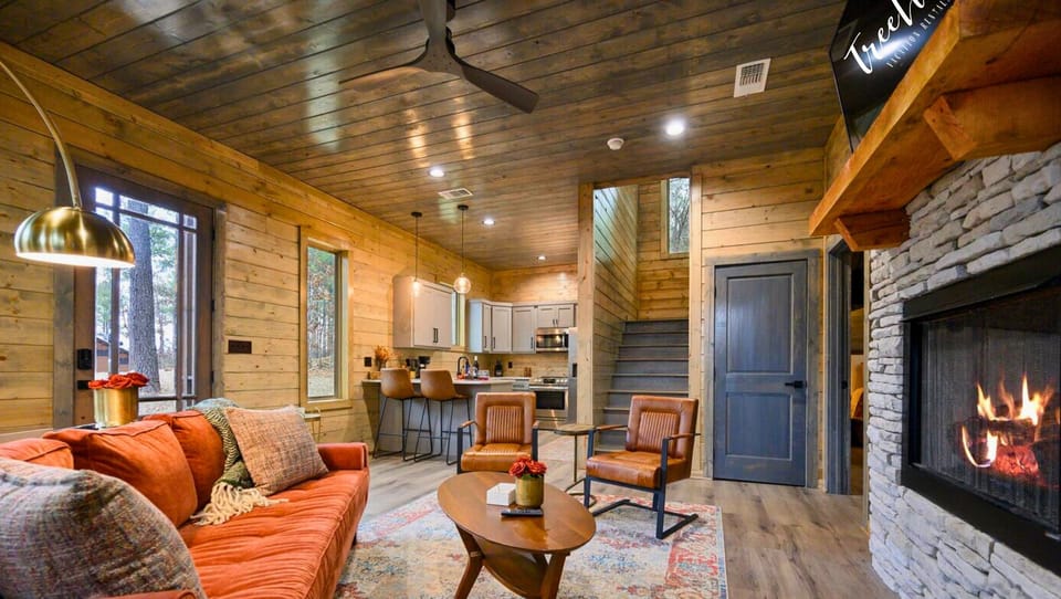 Relax in the living room with a warm fire and comfortable seating.