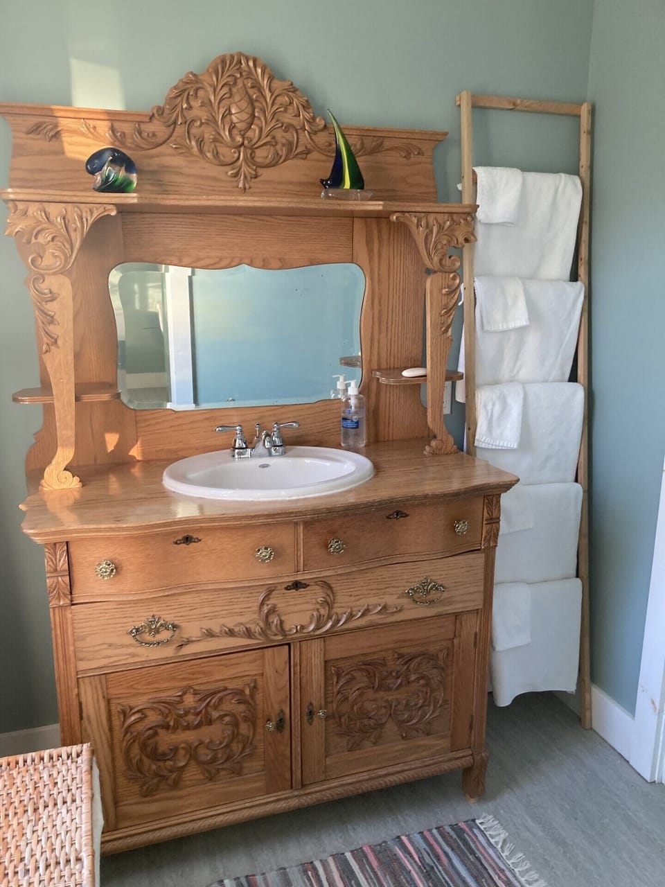 Upstairs antique bathroom vanity and towel ladder.