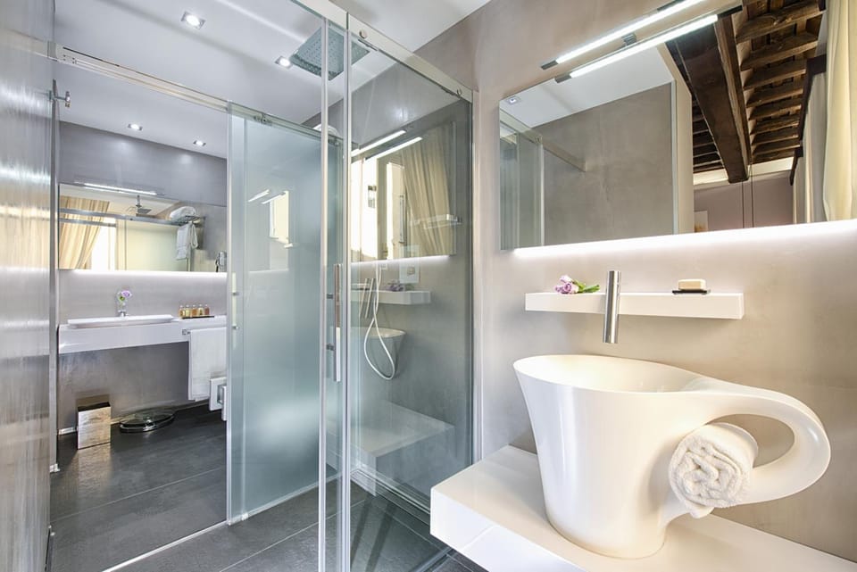Shower, designer toiletries, hair dryer, slippers