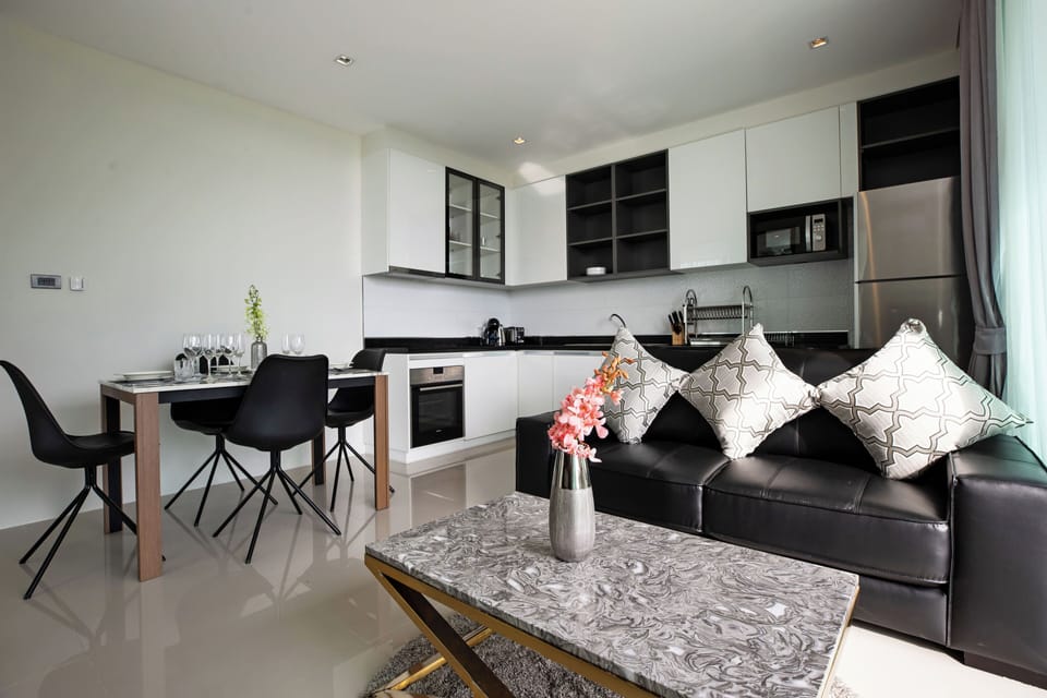 Deluxe Condo | Living area | Flat-screen TV