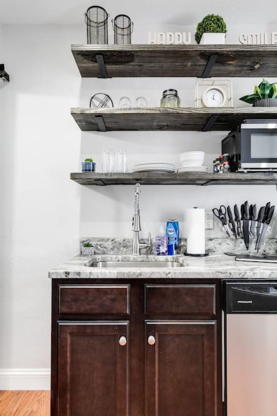 Well-appointed kitchen with open shelving, microwave, toaster, Keurig coffee maker, electric stove, dishwasher, fridge, freezer and more!