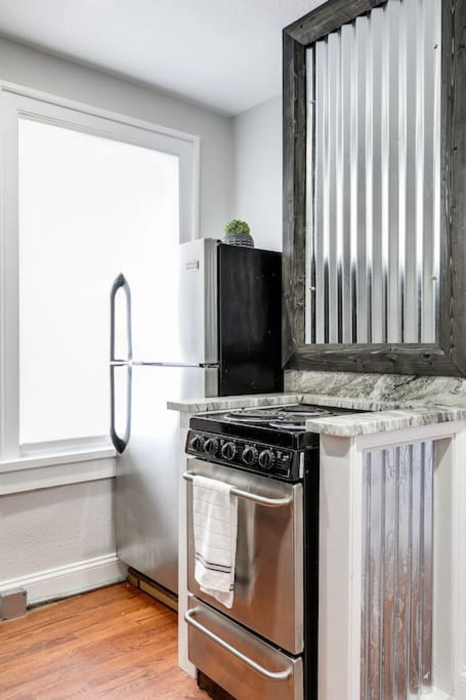 Well-appointed kitchen with open shelving, microwave, toaster, Keurig coffee maker, electric stove, dishwasher, fridge, freezer and more!