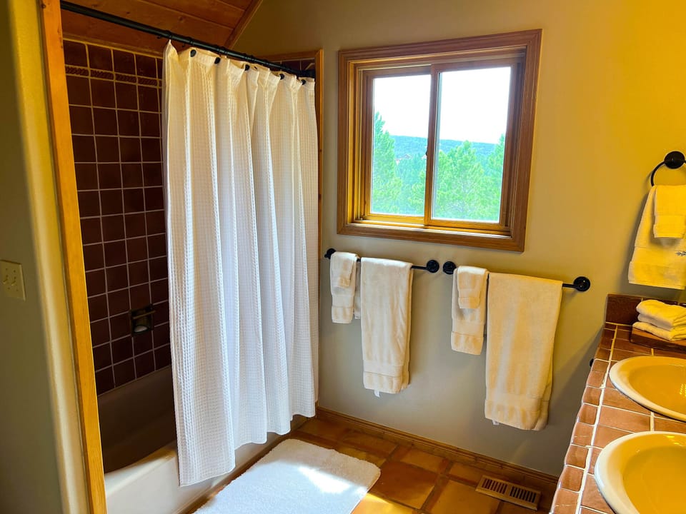 The second floor full bathroom has a tub shower and double sinks