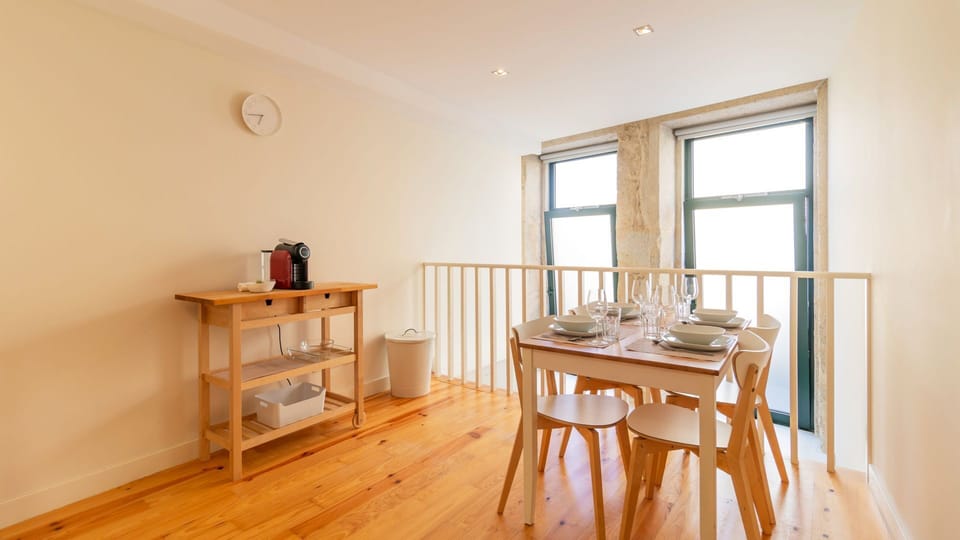 Gather around the dining table for memorable meals with loved ones, enjoying the bright atmosphere and the convenience of a coffee station nearby to start your day right. Large windows fill the space with natural light, perfect for morning conversation.