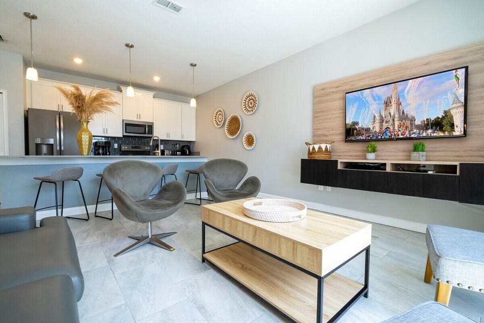 Step into this spacious, comfortable living area. The expansive room is adorned with tasteful decor, offering a blend of modern aesthetics and homey warmth. 