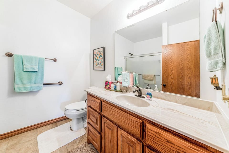 Hall bathroom just across the bedroom with two single beds.