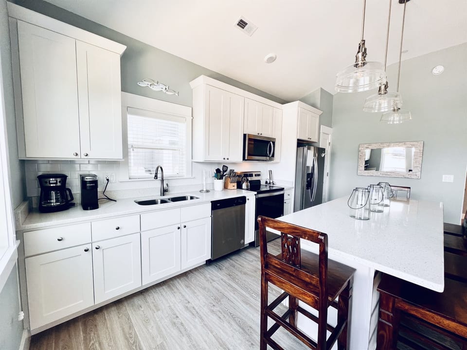 Elegance meets efficiency in this immaculate, well-appointed white kitchen.