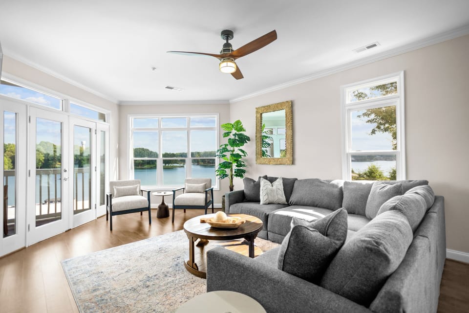 Living room with sectional, TV and amazing lake views.